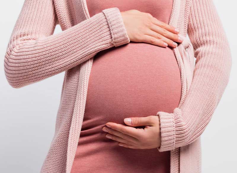 Pregnant woman holding her belly